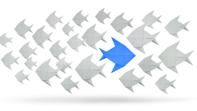 Group of white Fishes and single blue Fish Concept Of White Fishes with Blue Fish different Direction